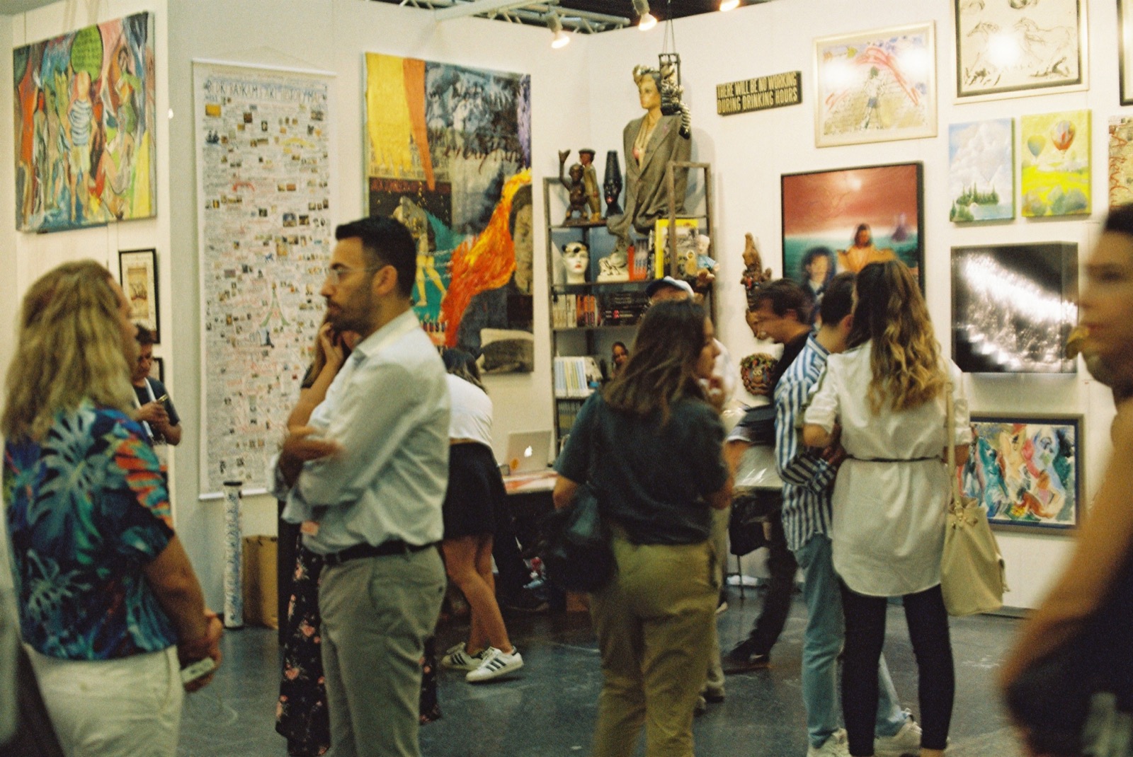 Reference image of guests mingling among artworks in a gallery
